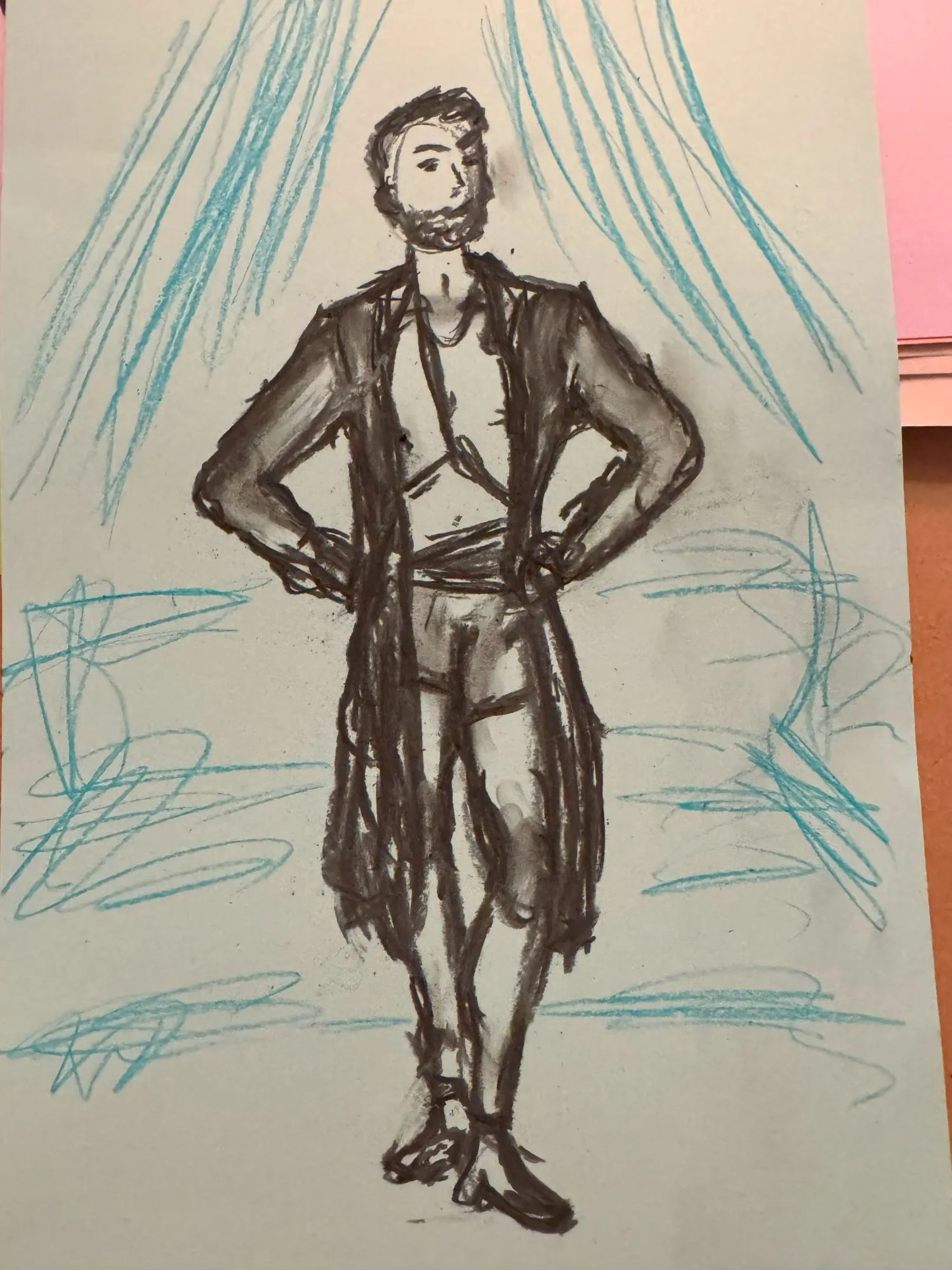 A figure drawn in charcoal wearing a long flowy coat, with the suggestion of a seat and curtain in the background
