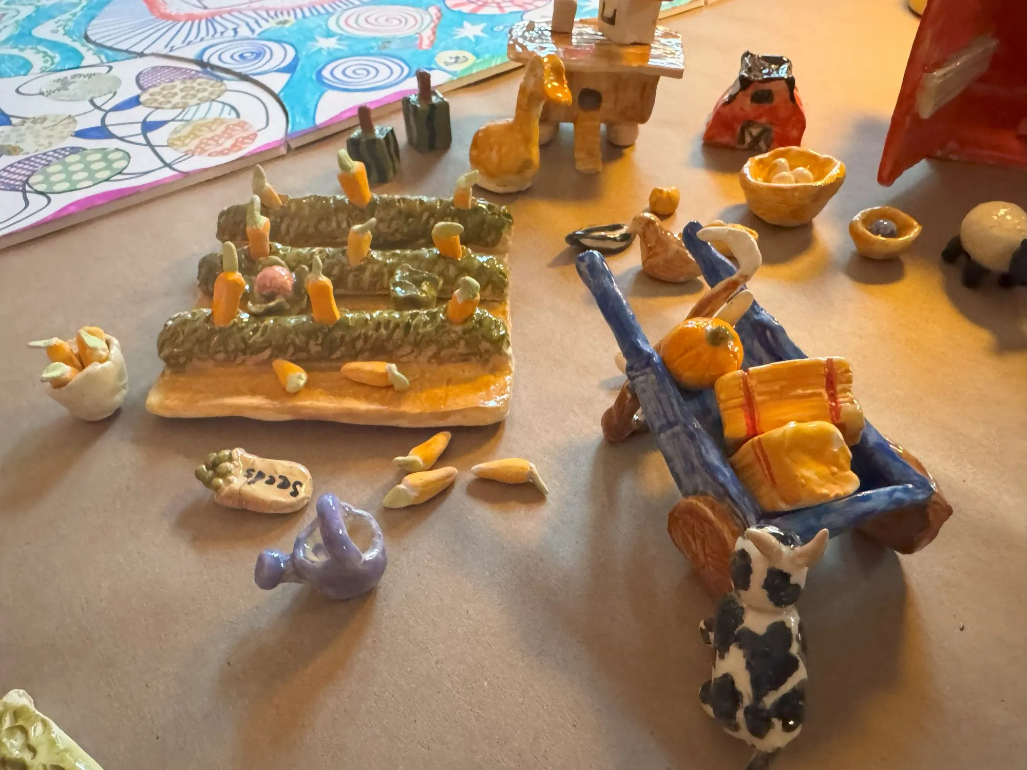 A ceramic crop field with carrots and a wheelbarrow