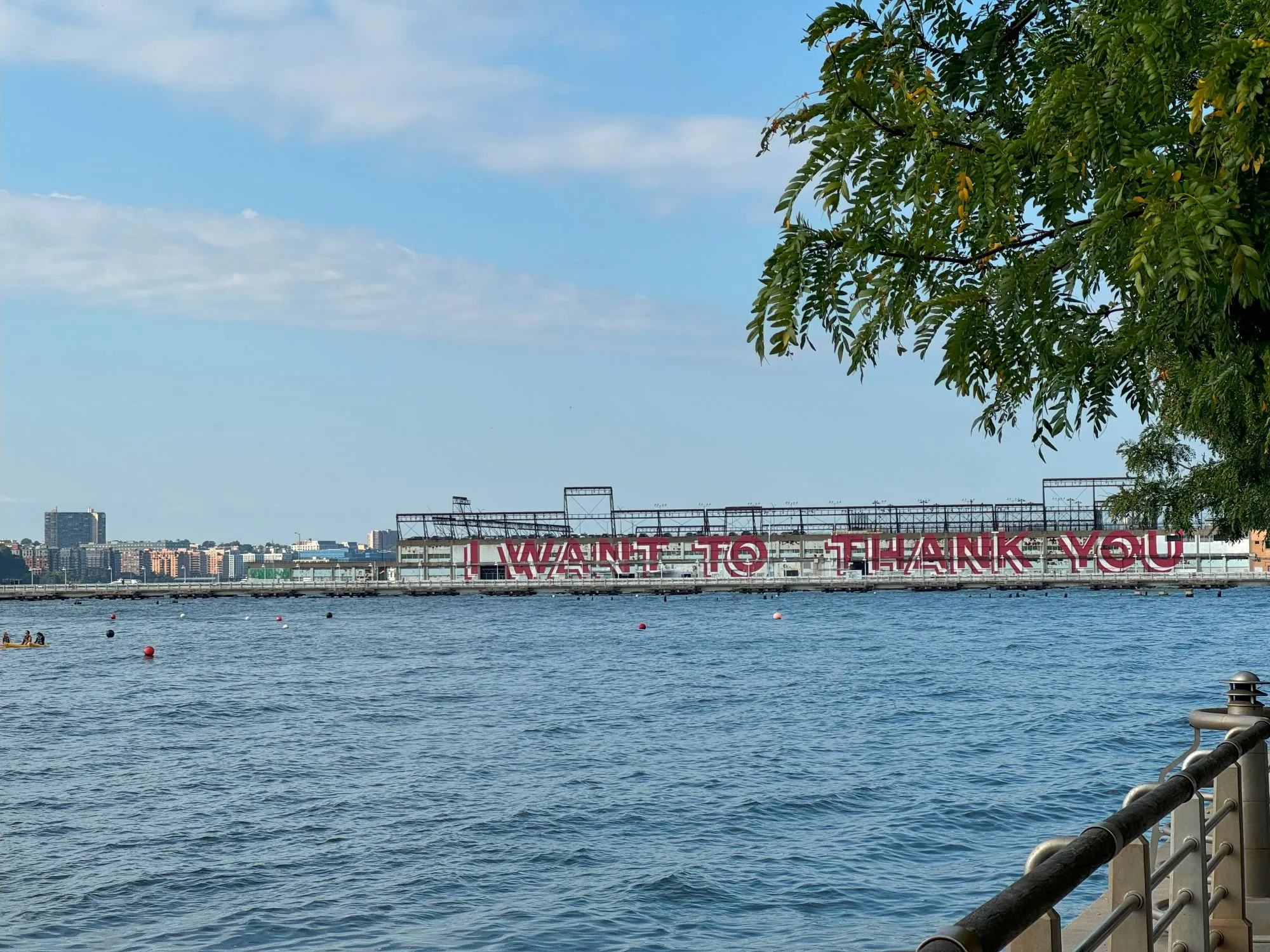 A picture of a pier from a distance with the words 'I want to thank you' painted on it