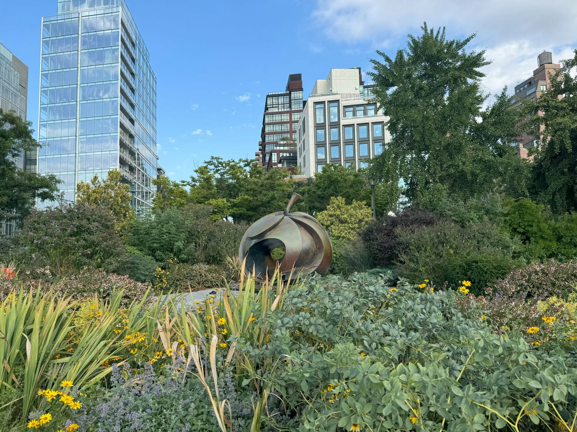 A metal statue of a stylized apple