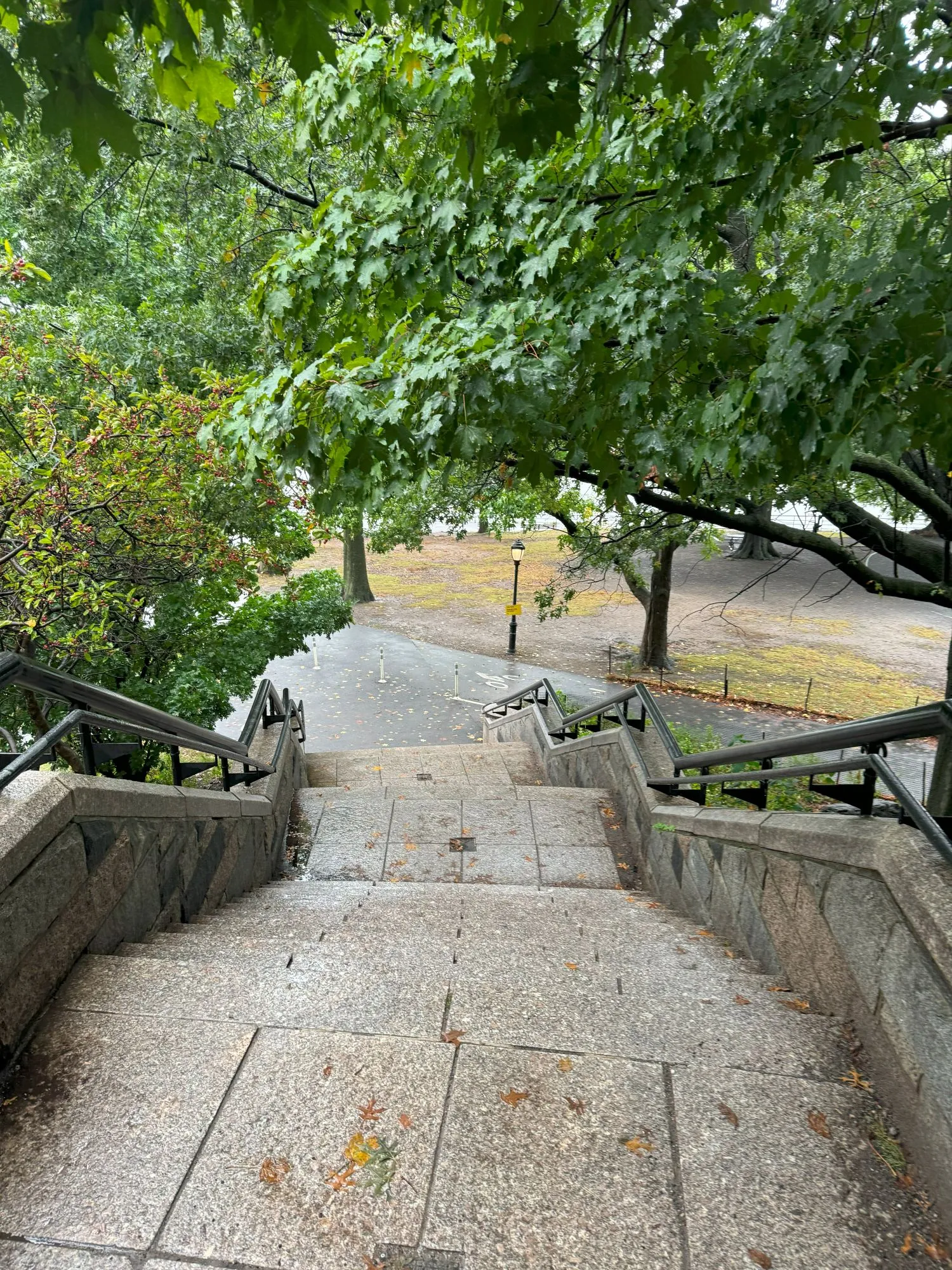 A picture from the top of an outdoor staircase on a rainy day