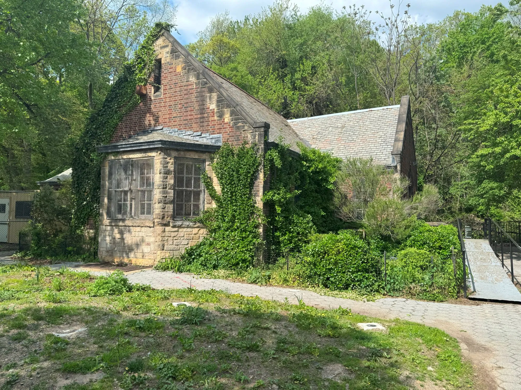 A small run-down building covered in plants