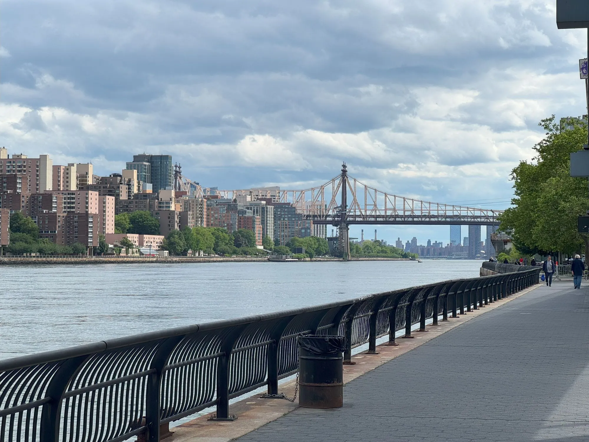 A bridge across the river to an area with many buildings