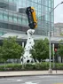 A large statue of a sitting dalmatian balancing a taxi on its nose